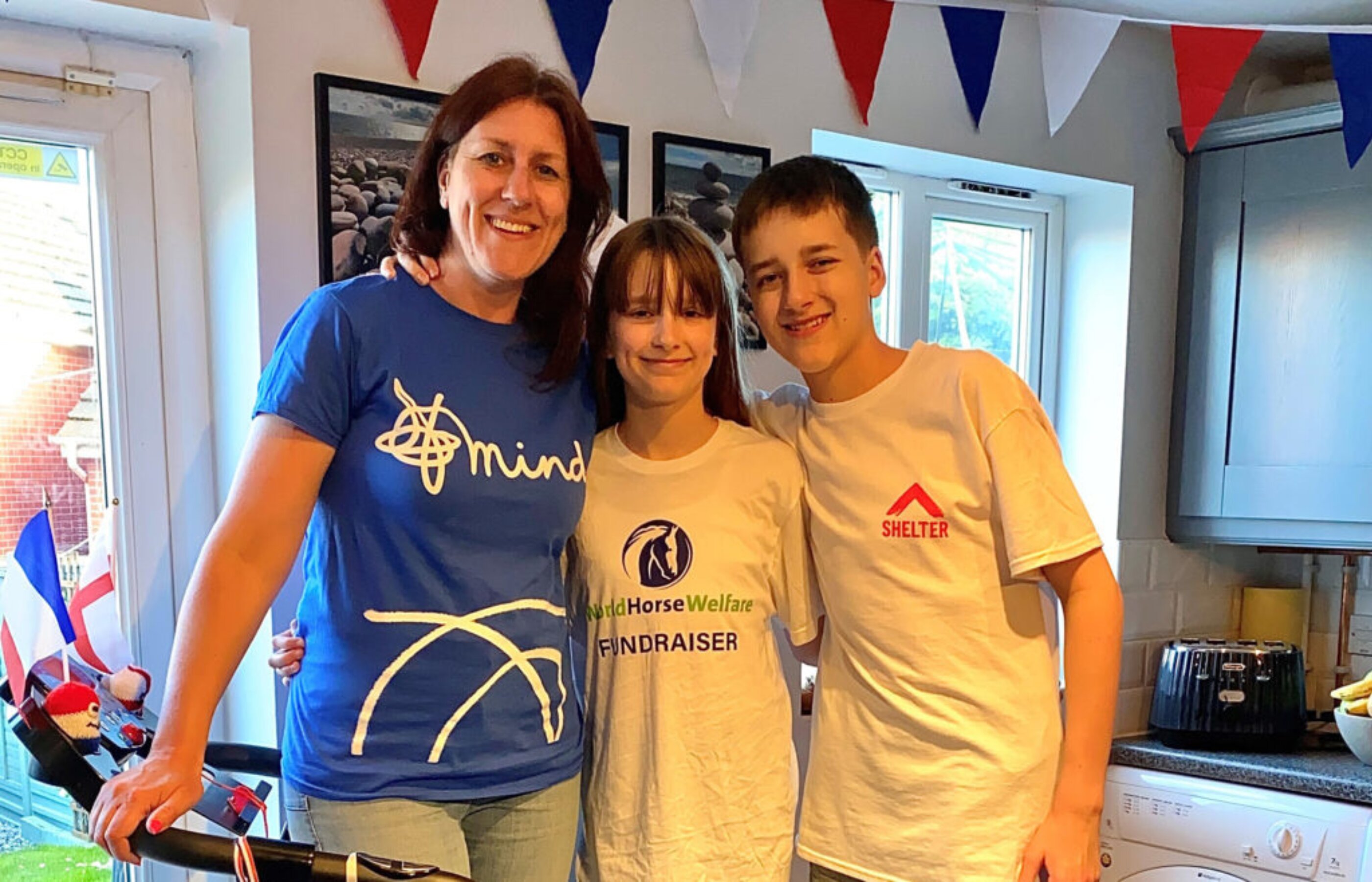 Emily Flint smiling for a photo with two children